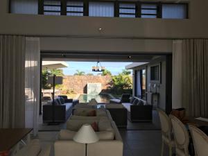 a living room with a large couch and chairs at Luxury Villas at Royal Park in Balaclava