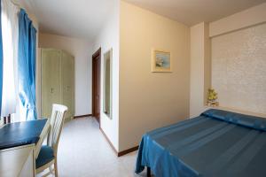 a bedroom with a bed and a desk and a table at Hotel Cristoforo Colombo in Osimo +48 photos
