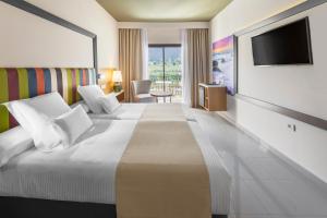 a hotel room with a large bed and a television at Hotel Gran Rey in Valle Gran Rey