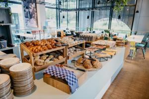 a bakery with a variety of breads and pastries at Hotel Casa Amsterdam in Amsterdam