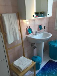 a bathroom with a sink and a mirror and a towel at Appartamento 500mt stadio San Siro in Milan
