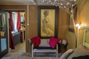 a living room with a portrait of a woman on the wall at Lyon Campagne in Rontalon