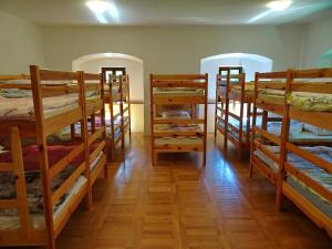 a room filled with lots of bunk beds at Dom Pristava in Jesenice