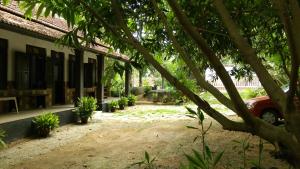 a building with a car parked in front of it at Veedu Homestays in Kollam