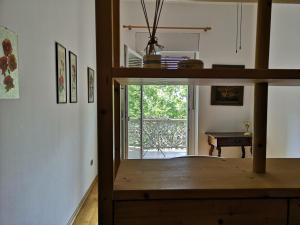 a room with a table and a view of a room at Spazioso e accogliente nel centro di Merano in Merano
