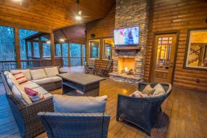 a living room with a fireplace in a log cabin at Indian Springs Lodge-Game Room, Video Game Table in Stephens Gap