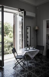 a dining room with a table and chairs and a window at MAG guest house in Palermo