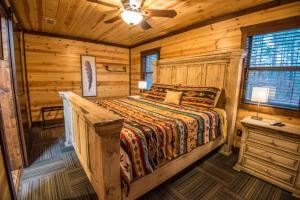 a bedroom with a bed in a log cabin at Indian Springs Lodge-Game Room, Video Game Table in Stephens Gap