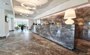 a lobby with a marble counter in a building at Hotel Villa Elsa in Marina di Massa