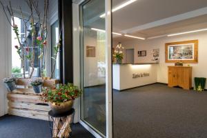 a lobby with potted plants in a building at Apartment Tgesa La Roiva mit Hallenbad und Sauna in Lenzerheide