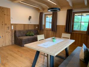 a living room with a table and a couch at Kererhof in Kals am Großglockner