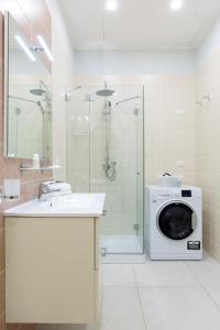 a bathroom with a washing machine and a shower at Dioniso’s Luxury Apartments Municipio in Naples