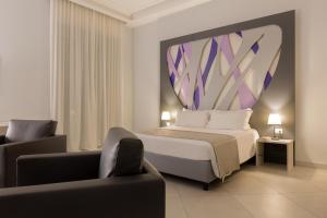 a bedroom with a king sized bed and a couch at Dioniso’s Luxury Apartments Municipio in Naples