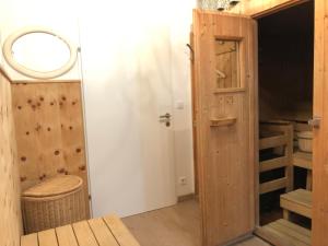 a room with a wooden door and a closet at Haus Hoffmann in Sonnenalpe Nassfeld +131 photos