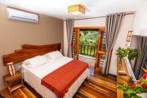 Postel nebo postele na pokoji v ubytování Vila Coqueiros Boutique Hotel