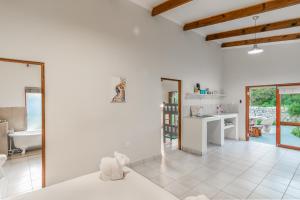 a white bathroom with a tub and a sink at Eastbrook River Self Catering Cottages in Sedgefield +49 photos