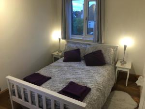 a bedroom with a bed with two pillows on it at Drum Brae Cottage in Edinburgh