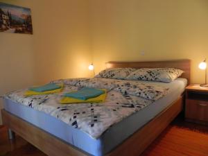 a bed in a bedroom with two pillows on it at Apartments Katalenić in Selce