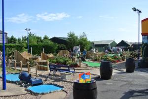 a childrens park with a playground with a play area at S460 8 BERTH CARAVAN ON THE GOLDEN PALM CHAPEL ST LEONARDS in Chapel Saint Leonards