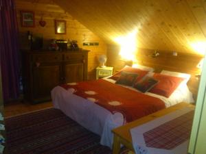 ル・トリーにあるChalet Gérardmer situé a LE THOLYの木製の部屋にベッド1台が備わるベッドルーム1室があります。