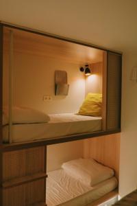 two bunk beds in a room with a mirror at Blai Blai Hostel in Zarautz