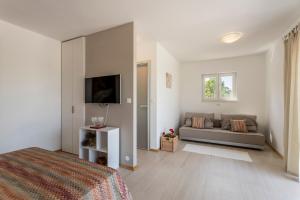 a white bedroom with a bed and a couch at Hacienda Noa in Grohote +42 photos