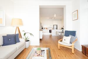 a living room with a couch and a table at Serene And Stylish Harbourside Apartment in Sydney