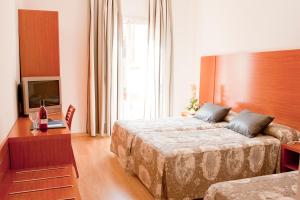Posteľ alebo postele v izbe v ubytovaní Ramblas Hotel