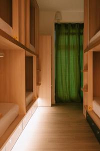 a room with a green curtain in front of a door at Blai Blai Hostel in Zarautz