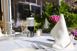 a white table with a bottle of wine and glasses at Hotel Puerto Palace in Puerto de la Cruz