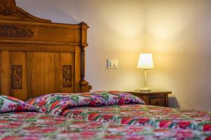 a bedroom with a bed and a lamp on a table at Hotel Medici in Florence +8 photos