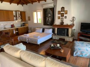 a living room with a bed and a couch and a fireplace at ★ Meniko's House ★ Amazing Sea View in Himare