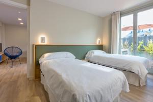 A bed or beds in a room at APARTAMENTOS BARCELLA TAPIA