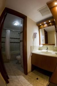a bathroom with a sink and a toilet and a mirror at Bayview Hotel in Lima