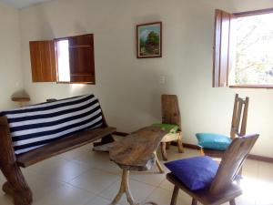 a room with two chairs and a bench and a table at Pouso Divino dos Pireneus in Pirenópolis +41 photos