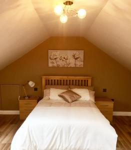 a bedroom with a large bed in a attic at Hartcliffe Retreat in Penistone
