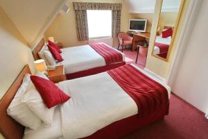 A bed or beds in a room at Dial House Hotel