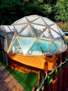 a wooden boat with a glass dome on the grass at zacisze in Junoszyno