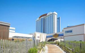 a fence in front of a city with a tall building at Hard Rock Hotel & Casino Atlantic City in Atlantic City