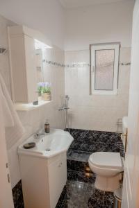 スパタにあるHelios Residenceのバスルーム(白い洗面台、トイレ付)