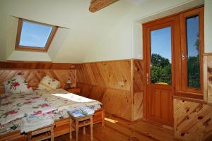 a bedroom with a bed and a table and a window at Viesu nams Smaidas in Lapmežciems