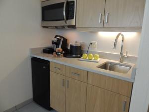 
a kitchen with a sink and a microwave at The Inn at Longwood Medical in Boston
