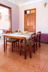 a dining room table with chairs and a wooden table at Starlight Hotel Mbale in Mbale