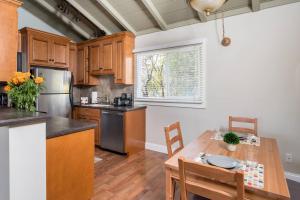 a kitchen with wooden cabinets and a wooden table at Spacious, Soaring Ceilings, Near Downtown MV, GOOG in Mountain View