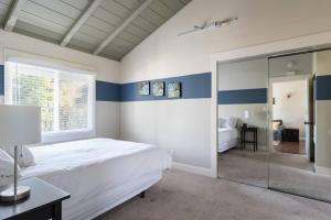 a bedroom with a large white bed and a mirror at Spacious, Soaring Ceilings, Near Downtown MV, GOOG in Mountain View