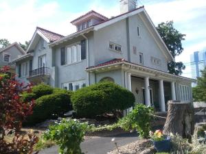 uma grande casa branca com arbustos à frente em Hanover House Bed and Breakfast em Niagara Falls