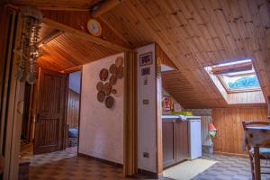 eine Küche mit Holzwänden und einer Decke mit einem Fenster in der Unterkunft Mansardato In Lurisia in Lurisia