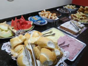 a table topped with lots of different types of food at Pousada Mãe Ternura Palace in Aparecida