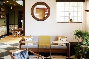 a living room with a couch and a mirror at Life House, Little Havana in Miami