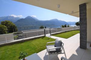 a balcony with a view of the water and mountains at Appartamento Fiordaliso Bellagio Wild Flowers - HOT TUB in Onno